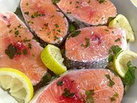 SLICES OF GRILLED SALMON AND FRESH GINGER